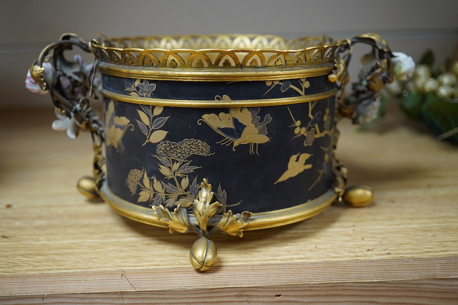 A French ormolu and lacquered jardiniere with porcelain mounted handles, stamped 'Bointaburet A Paris', together with a ‘pear’ candle display. Jardiniere width 23cm. Condition - one handle damaged, interior rubbed